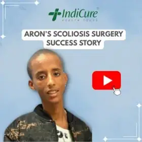 A headshot of a young man named Aron. The image promotes his successful scoliosis correction surgery, organized by IndiCure Health Tours.
